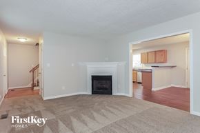 Knightdale house for rent - a living room with a fireplace and a kitchen