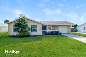 Tarpon Springs house for rent - A house with a well-maintained lawn and a clear sky above.