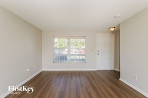 Tarpon Springs house for rent - A room with wooden floors and a window overlooking a street.