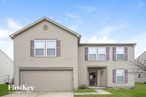 Indianapolis house for rent - A two-story house with a garage and a front porch.