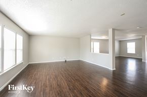 Indianapolis house for rent - A spacious room with wooden floors and white walls.