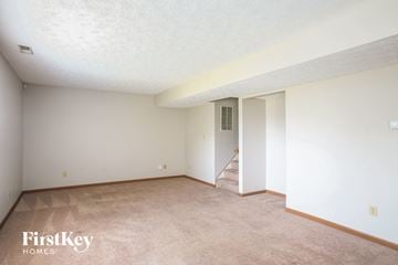Fishers house for rent - a spacious living room with carpet and white walls