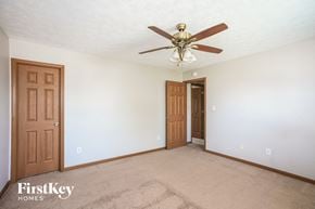 Fishers house for rent - a bedroom with a ceiling fan and a door to a closet