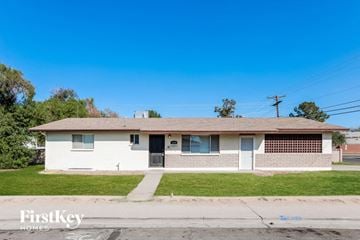 Mesa house for rent - a small white house with a sidewalk in front of it