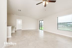 Riverview house for rent - an empty living room with a ceiling fan and a window