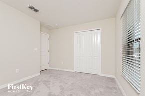 Riverview house for rent - a spacious living room with white walls and a door to a closet