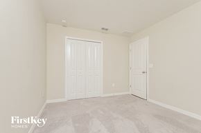 Riverview house for rent - a bedroom with two doors and a carpeted floor