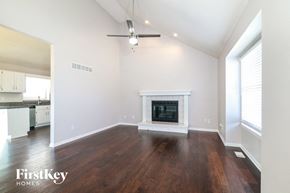 Greenwood house for rent - a living room with a fireplace and wooden floors