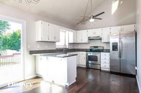Greenwood house for rent - a kitchen with white cabinets and stainless steel appliances