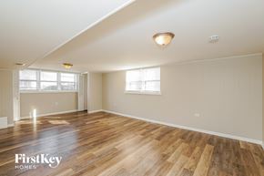 Oak Lawn house for rent - a living room with wood floors and white walls and a window