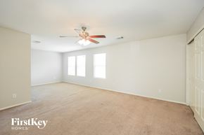 San Antonio house for rent - A spacious room with a ceiling fan and carpeted floor.