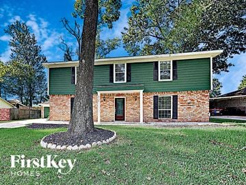 Conroe house for rent - a house with a tree in the front of it