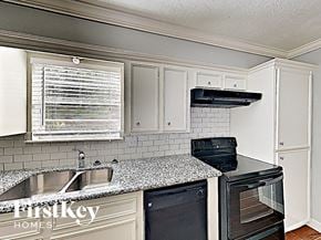 Conroe house for rent - a small kitchen with granite counter tops and white cabinets