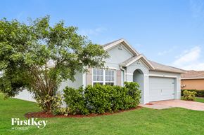 Cape Coral house for rent - A house with a tree in front of it.