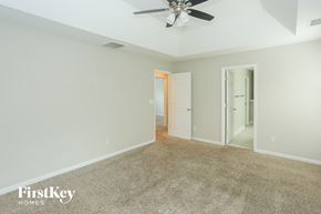 Indian Trail house for rent - a carpeted living room with a ceiling fan