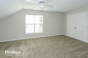 Indian Trail house for rent - a bedroom with a carpeted floor and a ceiling fan
