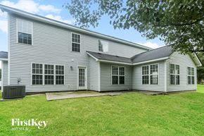 Indian Trail house for rent - a white house with white siding and a grassy yard