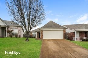 Cordova house for rent - a house with a white garage door and a driveway