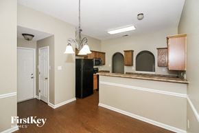 Cordova house for rent - a kitchen with a counter top and a black refrigerator