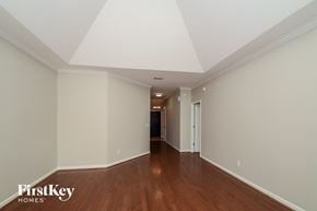 Calera house for rent - A long hallway with wood floors and white walls.