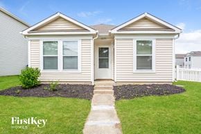 Noblesville house for rent - the front of a white house with a lawn and grass