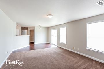 Noblesville house for rent - a living room with a carpet and a kitchen
