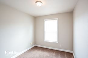 Noblesville house for rent - a bedroom with white walls and a window and carpet