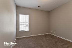 Cordova house for rent - a bedroom with a window and a carpeted floor