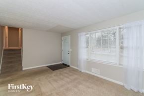 Woodstock house for rent - A room with a carpeted floor and a window with white curtains.