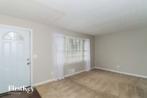 Woodstock house for rent - A room with a door and a window with curtains.