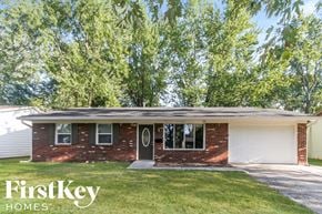 Indianapolis house for rent - a small brick house with a white garage door