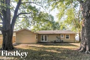 Indianapolis house for rent - a small tan house with a yard and trees