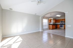 Riverview house for rent - an empty kitchen and living room with a ceiling fan