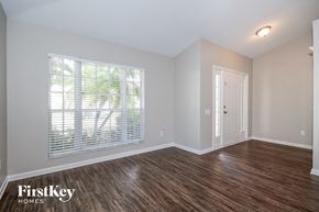 Riverview house for rent - the living room of a home with a large window and wood flooring