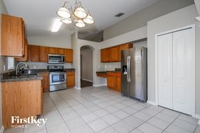 Riverview house for rent - a kitchen with wooden cabinets and stainless steel appliances
