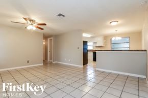 Largo house for rent - an empty living room and kitchen with a ceiling fan
