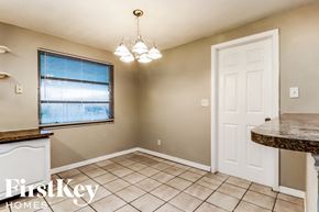 Largo house for rent - an empty kitchen and dining room with tile flooring and a window