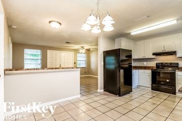 Largo house for rent - a kitchen with a counter top and a black refrigerator