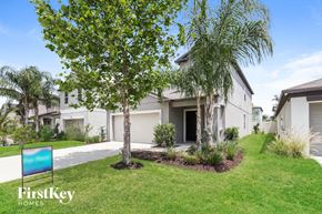 Riverview house for rent - A tree stands in front of a house with a sign that says FirstKey Homes.