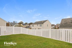 Indian Trail house for rent - A white picket fence in a grassy area with houses in the background.
