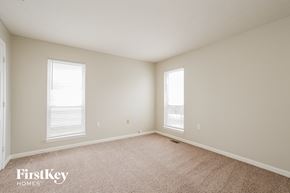 Indianapolis house for rent - A room with a carpet floor and two windows.
