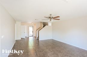 Buckeye house for rent - A spacious room with a fan and tiled floor.