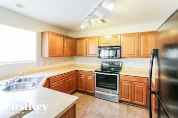 Buckeye house for rent - A kitchen with wooden cabinets and stainless steel appliances.