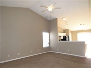 Indianapolis house for rent - an empty living room with a ceiling fan