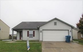 Indianapolis house for rent - a white house with a blue trash can in front of it