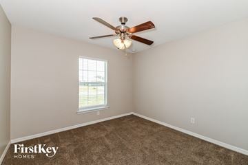 Cape Coral house for rent - a living room with carpet and a ceiling fan