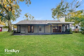 Plant City house for rent - the back of a house with a grassy yard and a