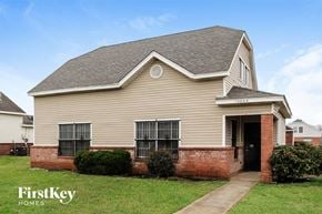 Dallas house for rent - the front of a house with a brick porch and a sidewalk