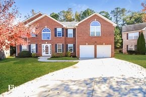 Mcdonough house for rent - a large brick house with a white driveway in front of it