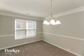 Mcdonough house for rent - a dining room with three lamps and a window
